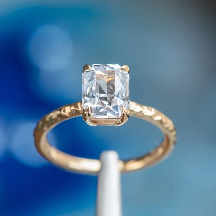 305ct Radiant Cut Sapphire Evergreen Solitaire in 14k Yellow Gold Tucson Show Earrings
